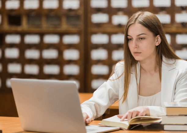 A student scans records for certified academic translation with Translation Services in Jersey City at a quiet desk.