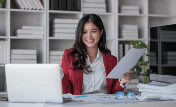 A translator applies a certified stamp and signs pages for fast Translation Services in Hoboken at a tidy desk.