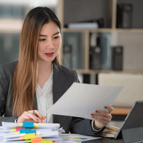 A translator proofreads certified academic translation of a diploma for Translation Services in East Orange at a desk.